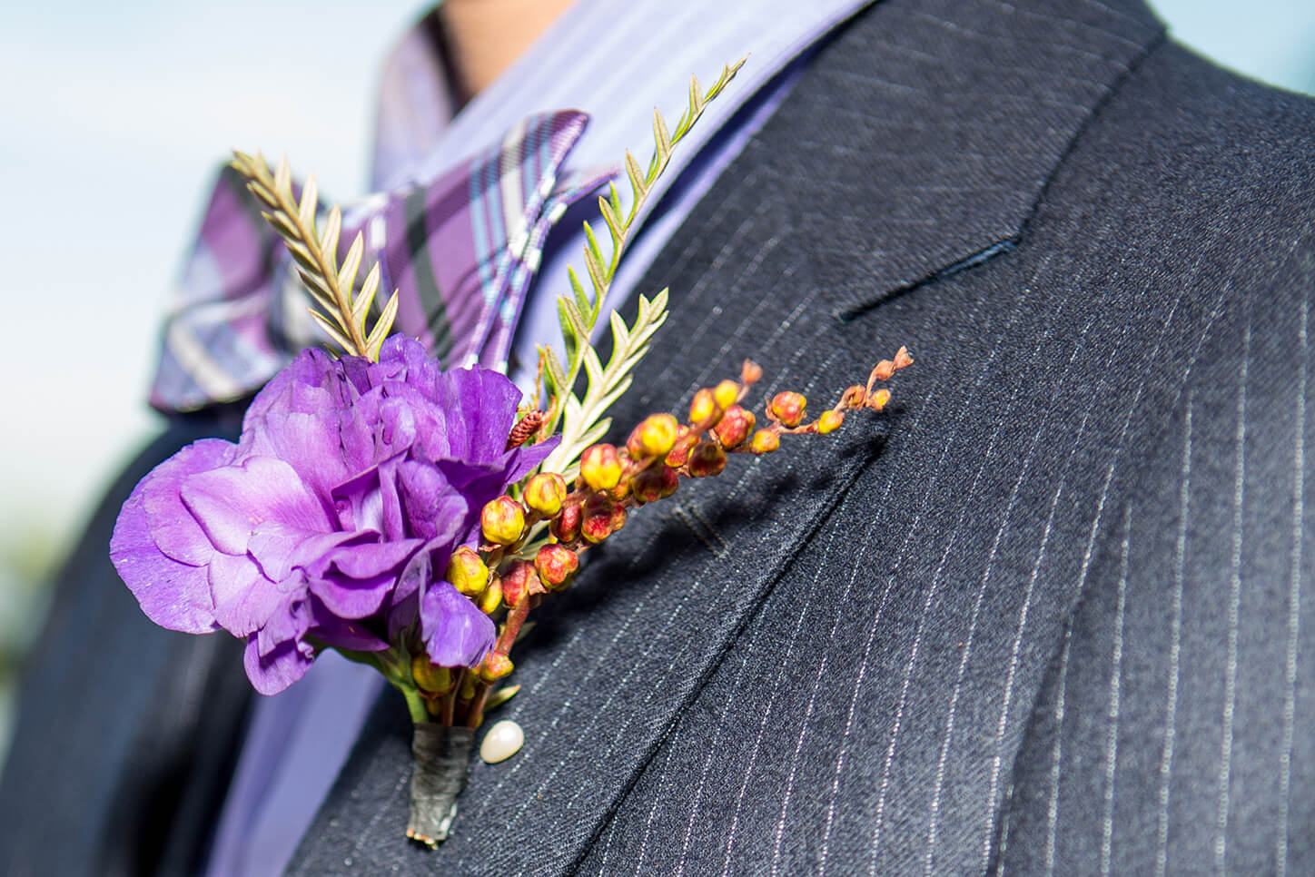 Featured detail shot of groom’s boutonniere for wedding vocabulary blog post by White House Wedding Photography