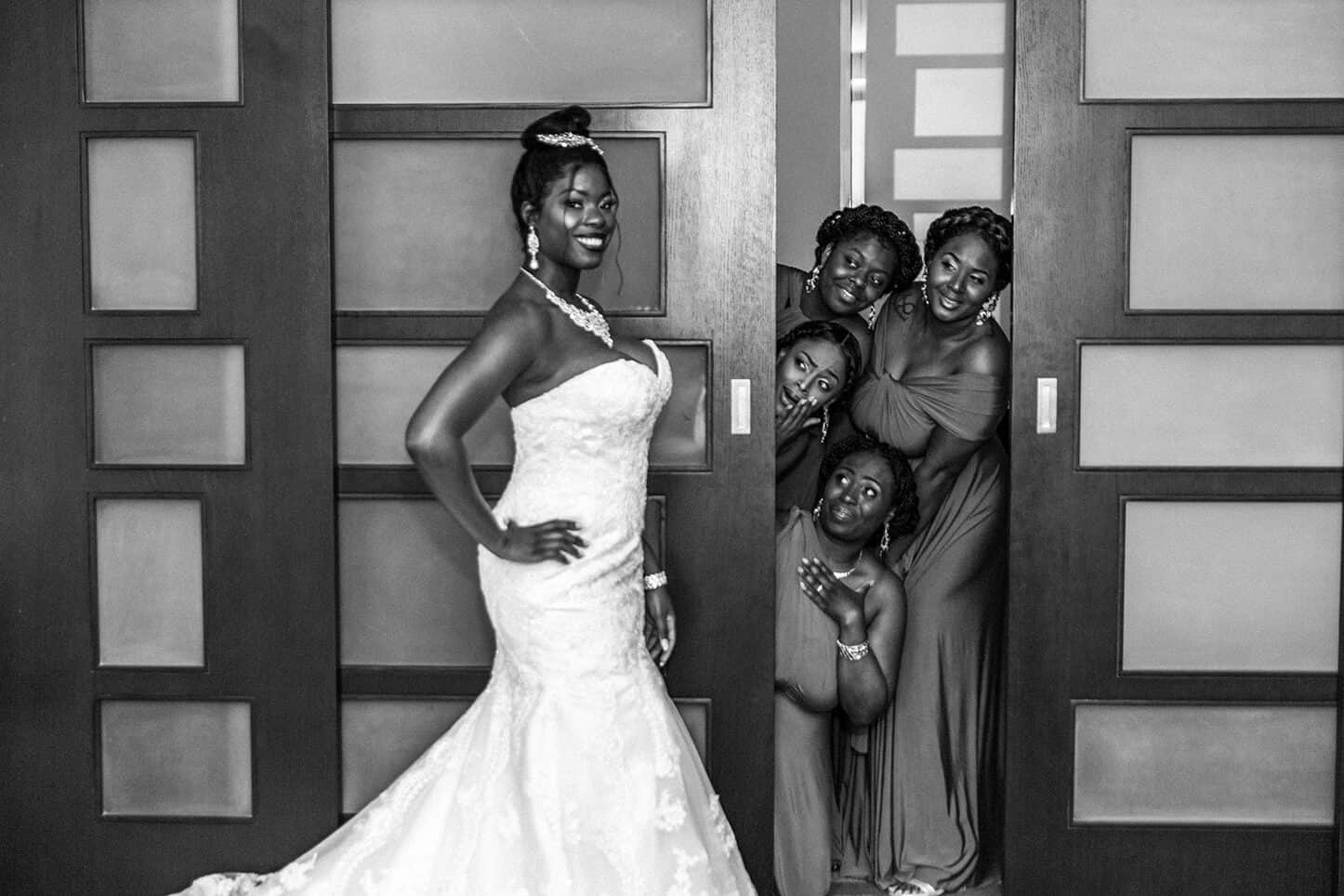 Best wedding day photo of bride doing a first look with her bridesmaids.