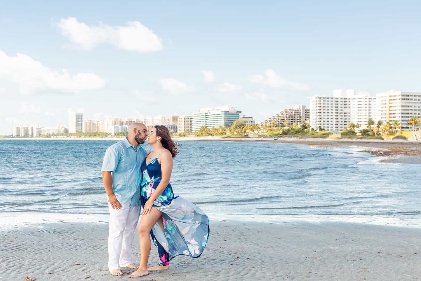 Couple posing for their engagement photo session on the Beach | 7 Things to Consider Before Picking Your Wedding Date