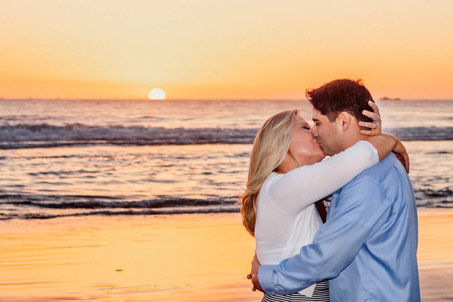 Sunset Photo of a couple kissing on the beach in CA by Miami Engagement Photographer