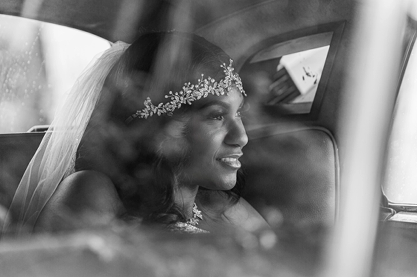 Bride posing beside a vintage Rolls-Royce at the Bamboo Gallery wedding venue in Davie, Florida.