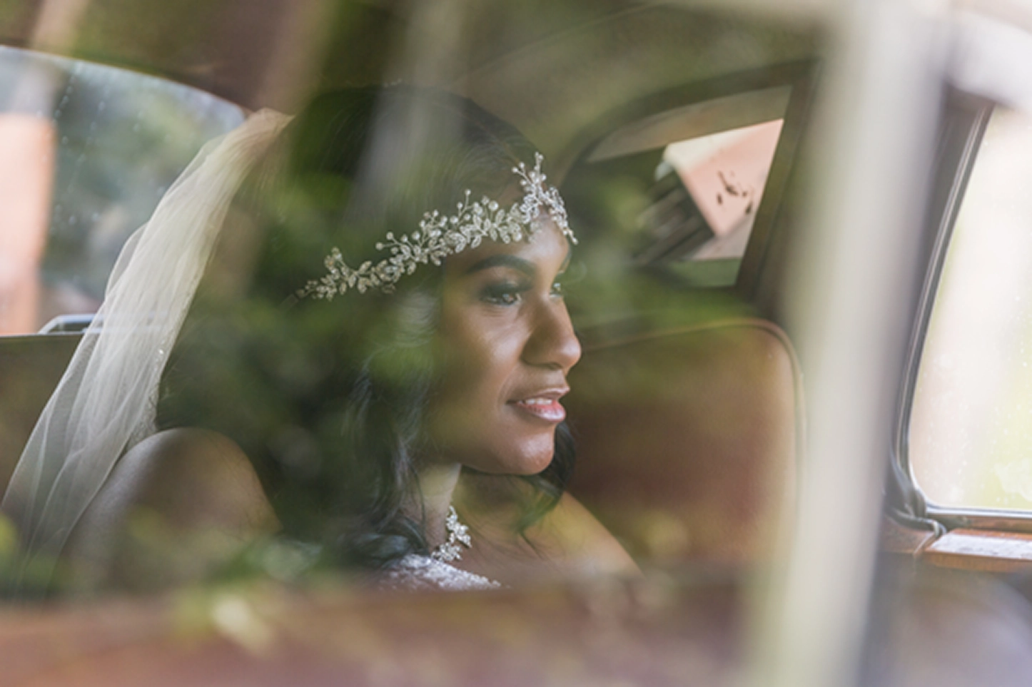Bride posing beside a vintage Rolls-Royce at the Bamboo Gallery wedding venue in Davie, Florida.
