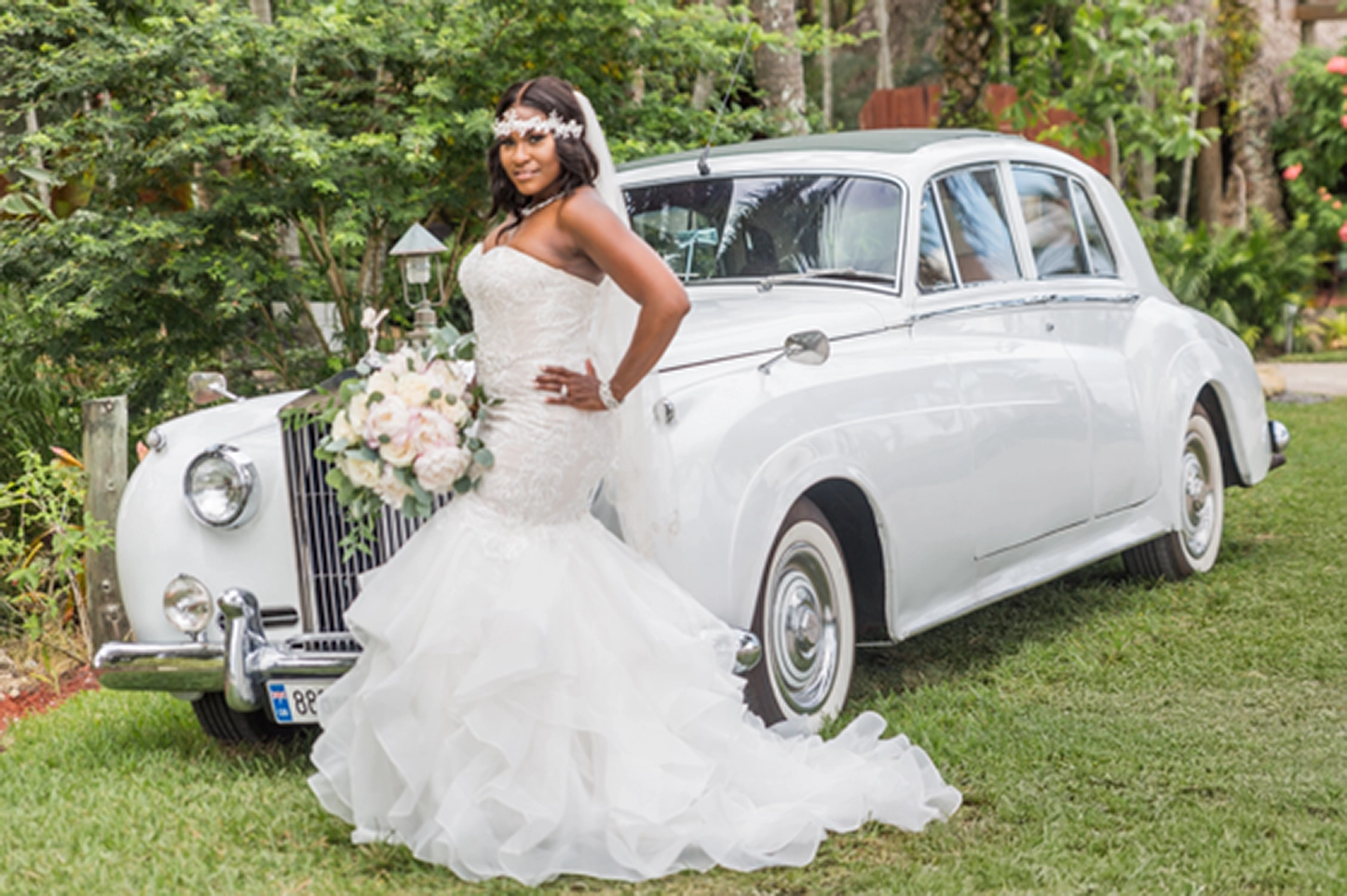 Bride posing beside a vintage Rolls-Royce at the Bamboo Gallery wedding venue in Davie, Florida.