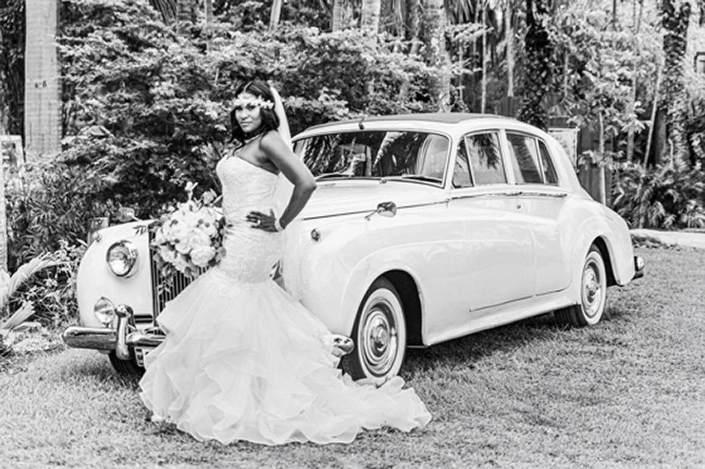 Bride posing beside a vintage Rolls-Royce at the Bamboo Gallery wedding venue in Davie, Florida.