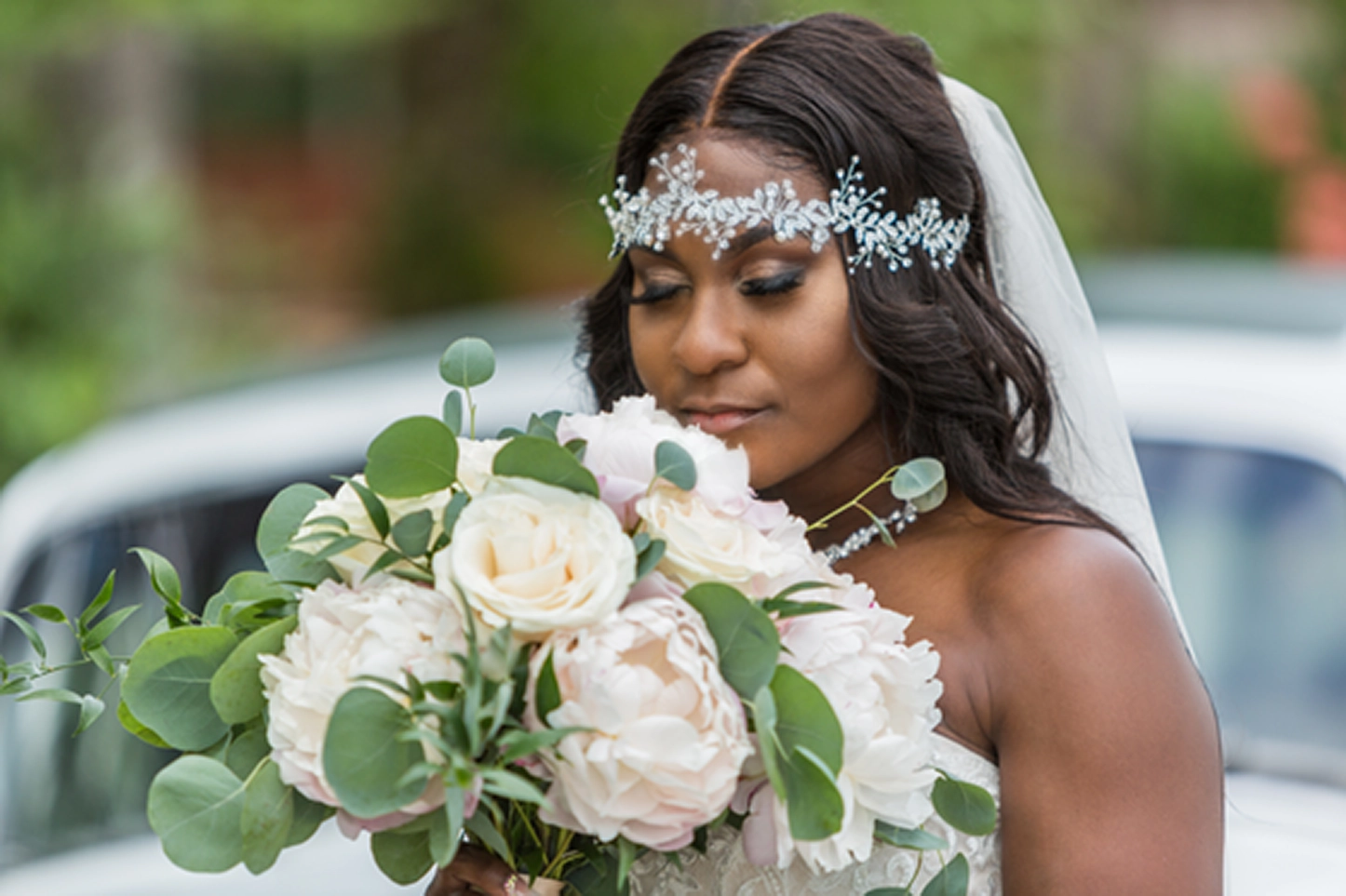 Bride posing beside a vintage Rolls-Royce at the Bamboo Gallery wedding venue in Davie, Florida.