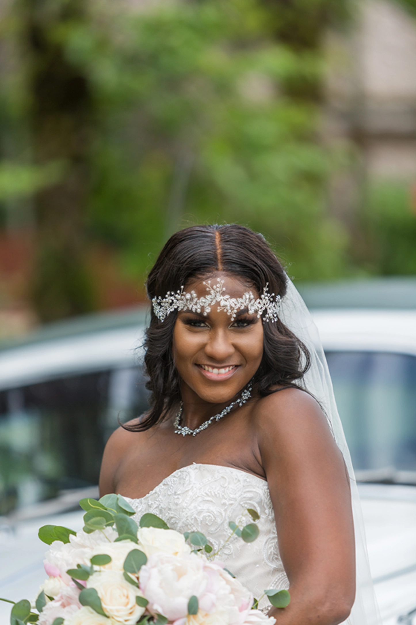 Bride posing beside a vintage Rolls-Royce at the Bamboo Gallery wedding venue in Davie, Florida.