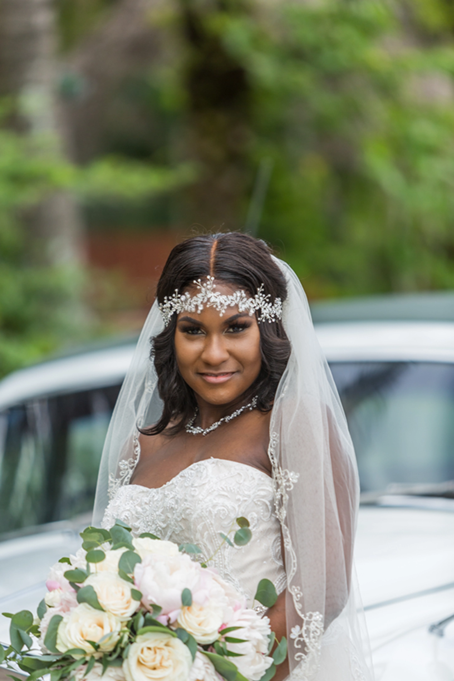 Bride posing beside a vintage Rolls-Royce at the Bamboo Gallery wedding venue in Davie, Florida.