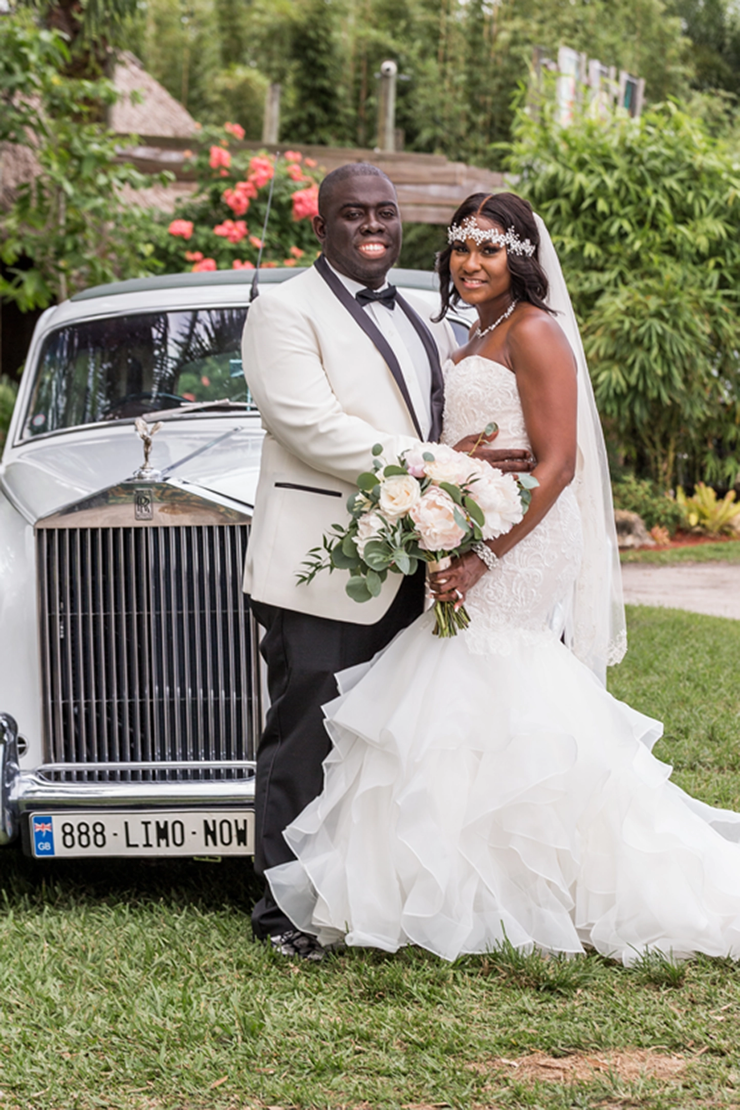 Bride and groom pose inside and beside a classic vintage Rolls-Royce at the Bamboo Gallery wedding venue in Davie, Florida.