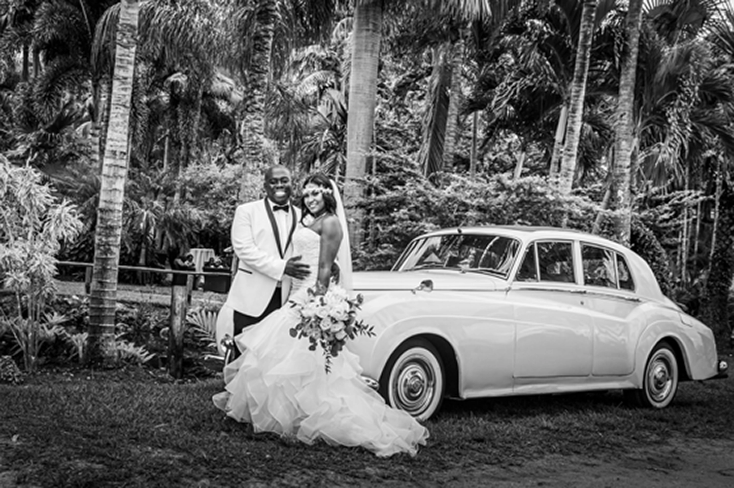 Bride and groom pose inside and beside a classic vintage Rolls-Royce at the Bamboo Gallery wedding venue in Davie, Florida.