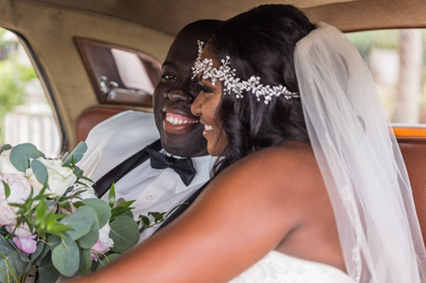 Bride and groom pose inside and beside a classic vintage Rolls-Royce at the Bamboo Gallery wedding venue in Davie, Florida.