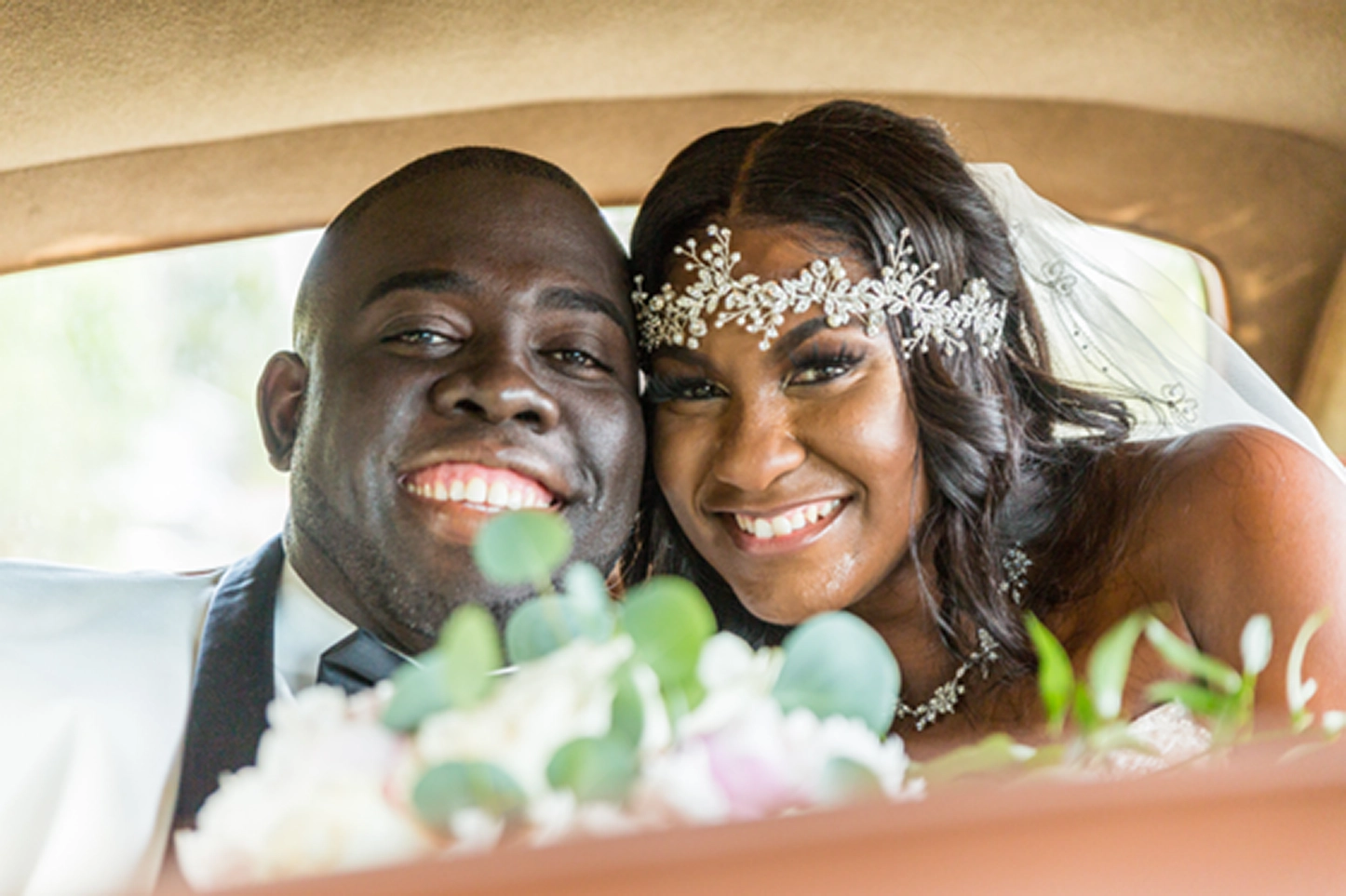 Bride and groom pose inside and beside a classic vintage Rolls-Royce at the Bamboo Gallery wedding venue in Davie, Florida.
