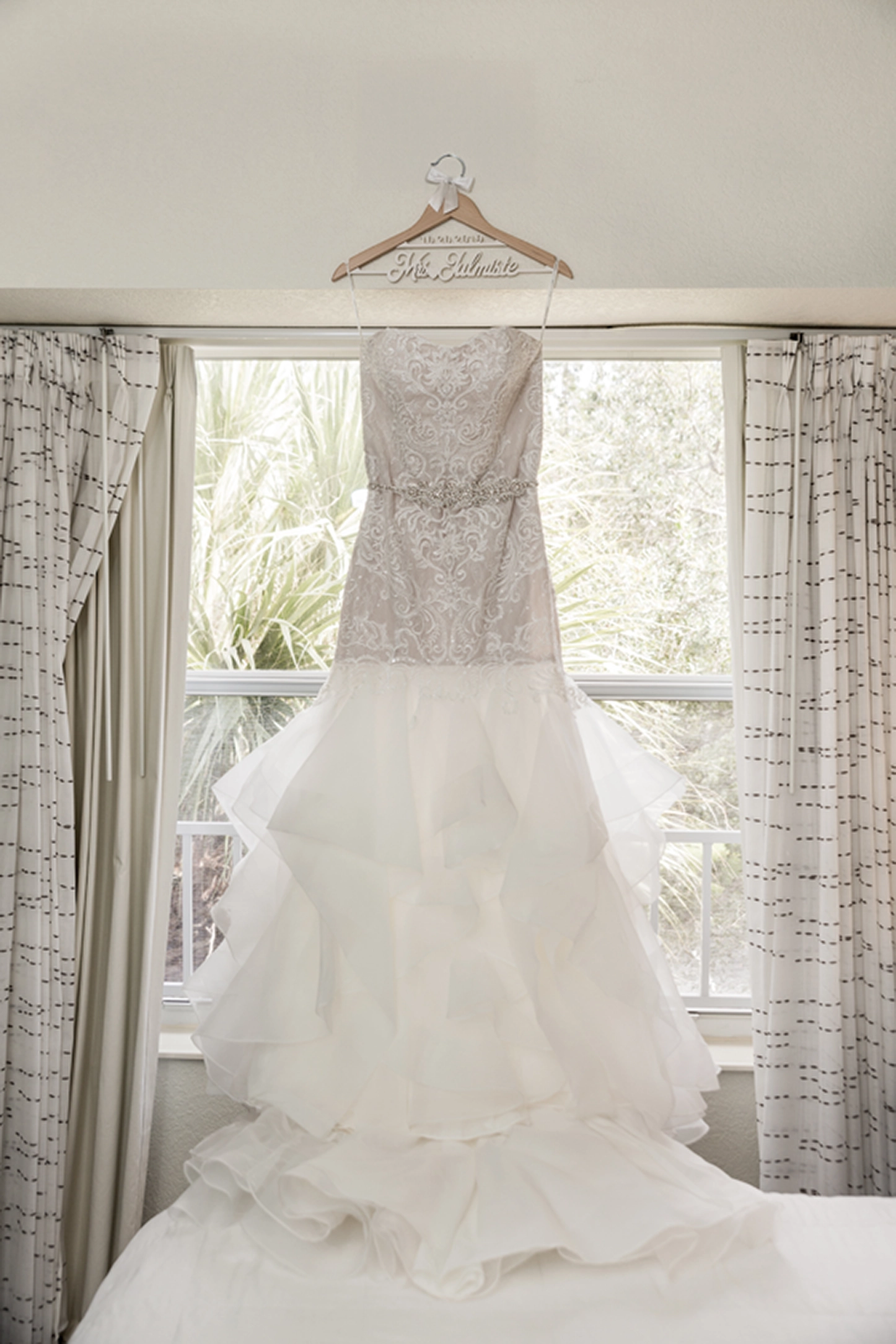 Detail shot of a wedding dress hanging before a Bamboo Gallery wedding in Fort Lauderdale