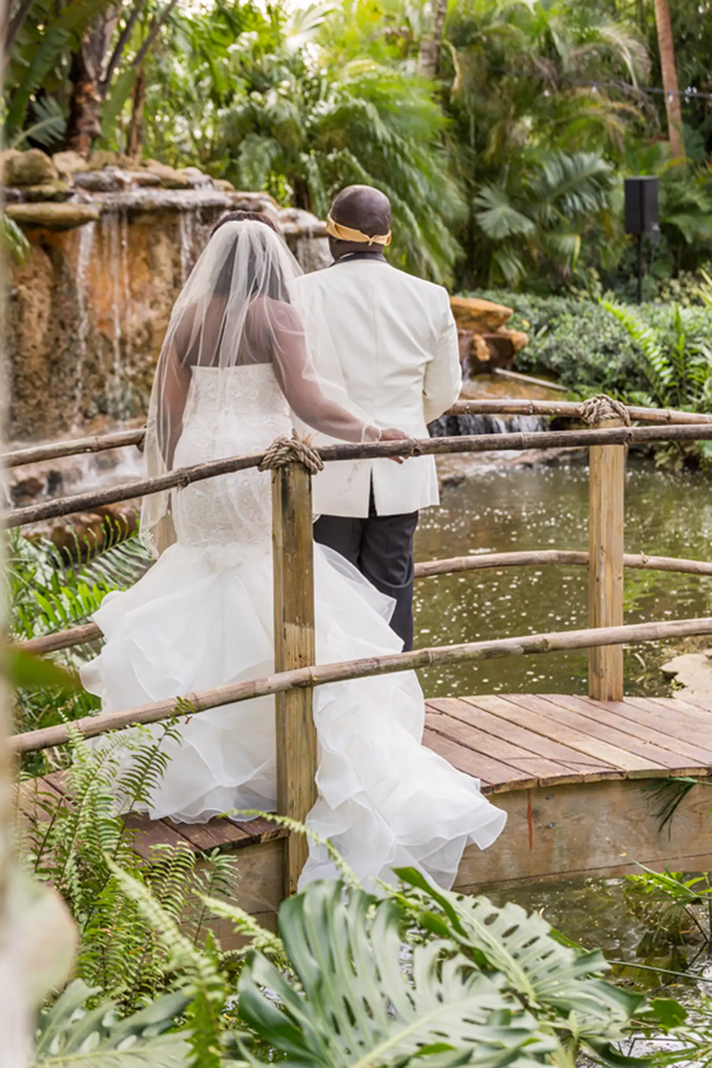 Bride and groom share an emotional first look at the lush Bamboo Gallery wedding venue in Davie, Florida.