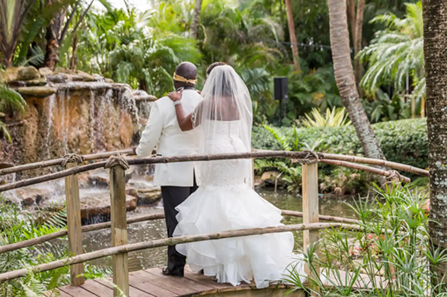Bride and groom share an emotional first look at the lush Bamboo Gallery wedding venue in Davie, Florida.