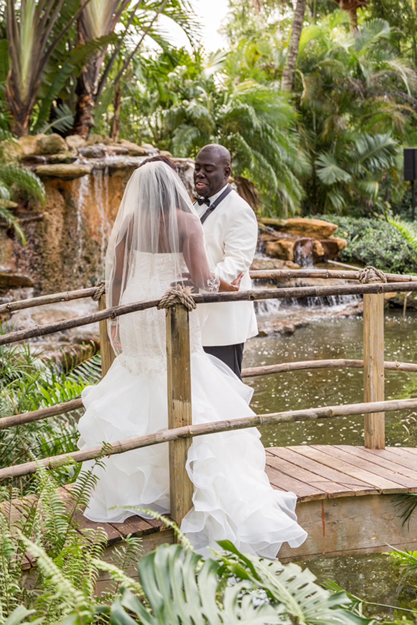 Bride and groom share an emotional first look at the lush Bamboo Gallery wedding venue in Davie, Florida.
