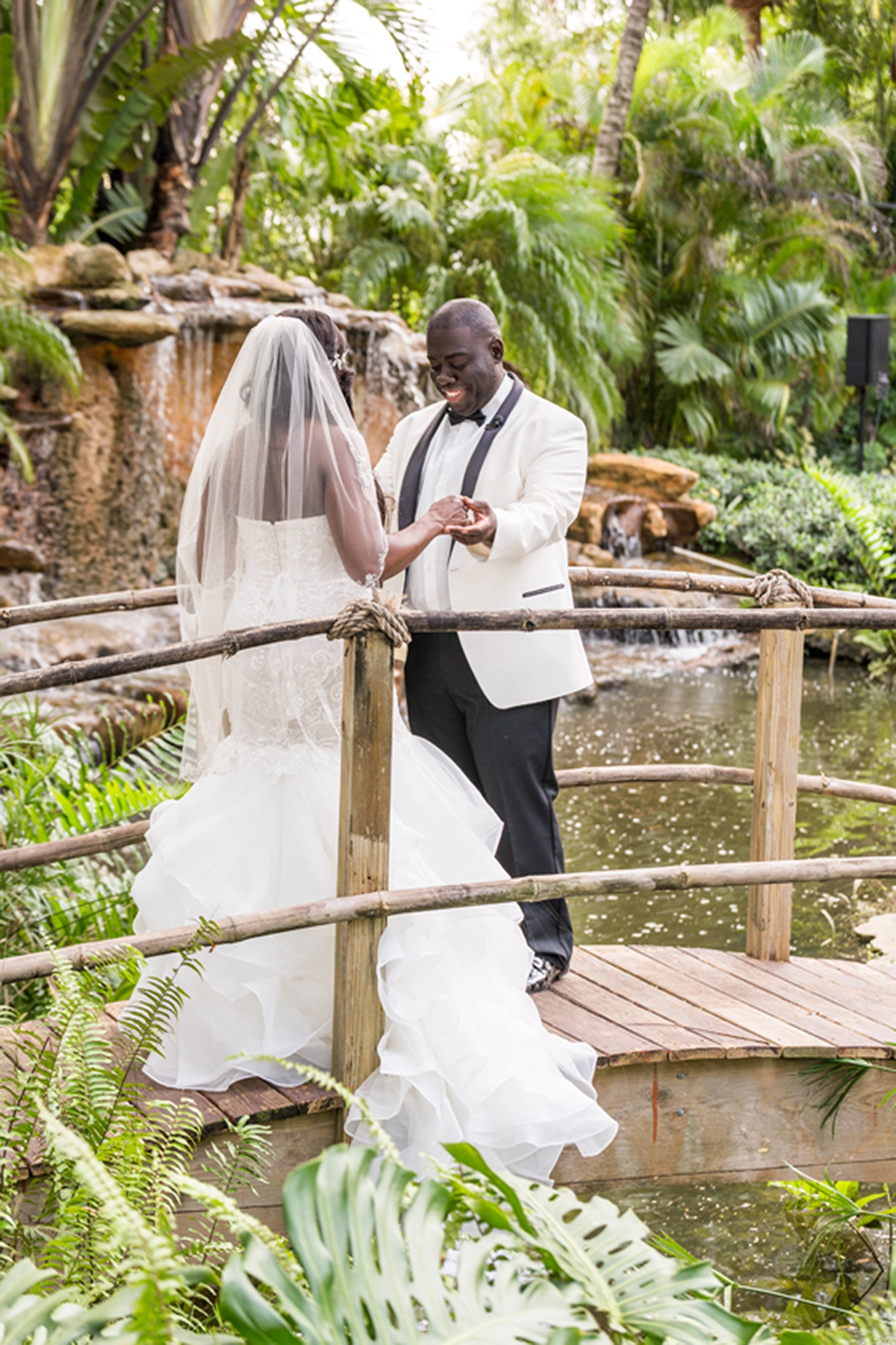 Bride and groom share an emotional first look at the lush Bamboo Gallery wedding venue in Davie, Florida.