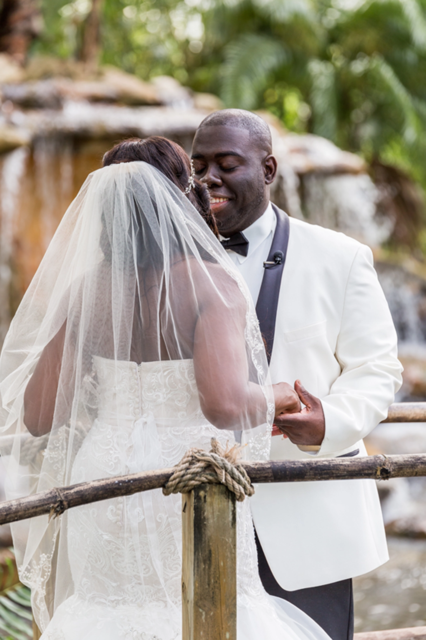 Bride and groom share an emotional first look at the lush Bamboo Gallery wedding venue in Davie, Florida.