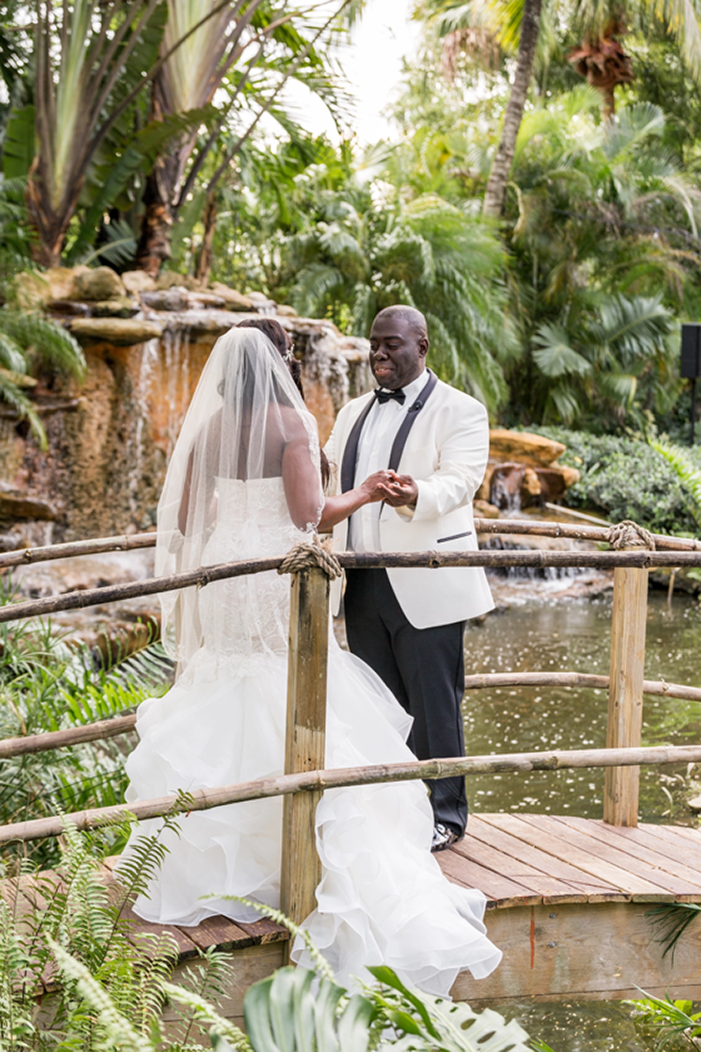 Bride and groom share an emotional first look at the lush Bamboo Gallery wedding venue in Davie, Florida.