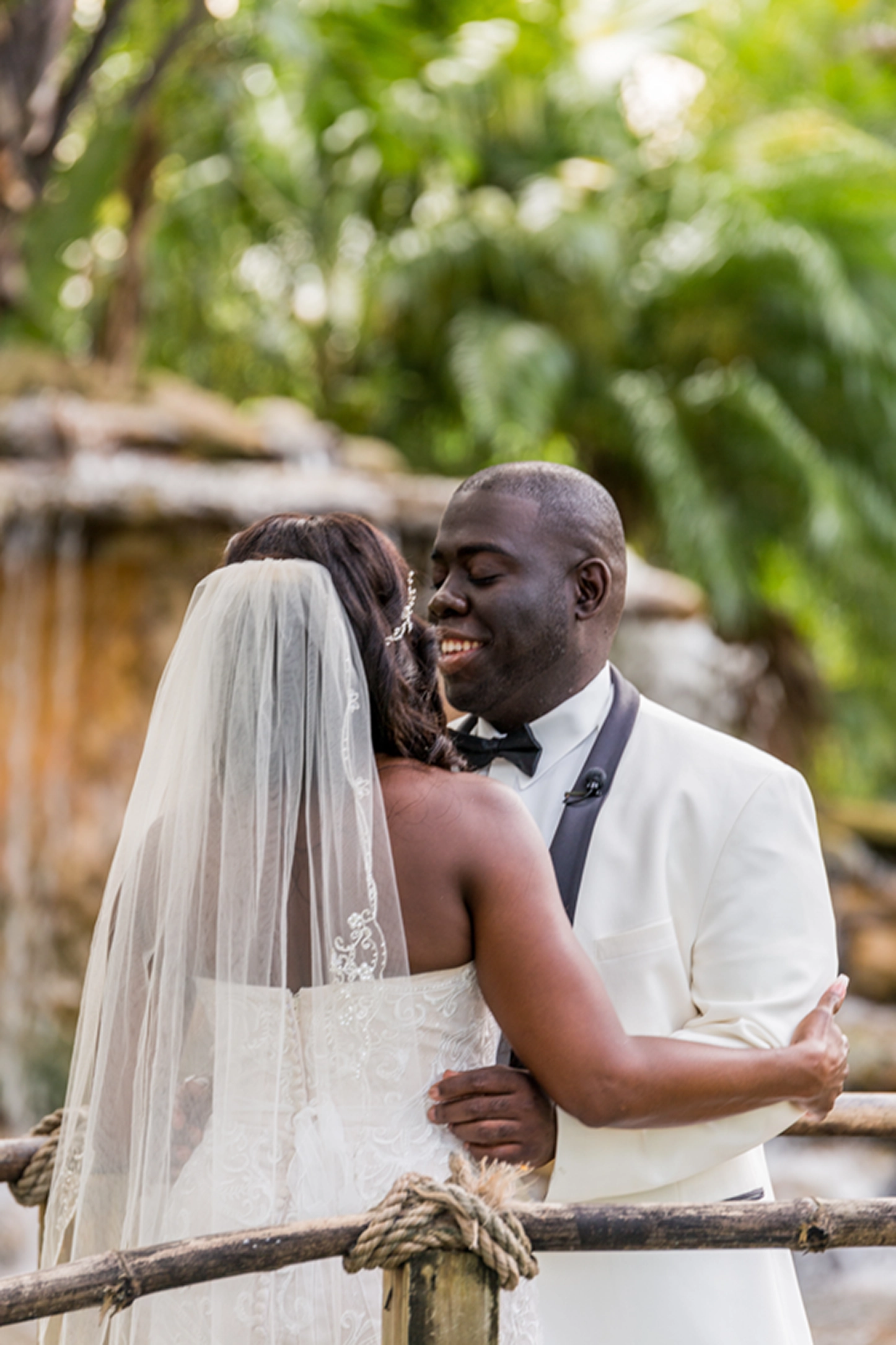 Bride and groom share an emotional first look at the lush Bamboo Gallery wedding venue in Davie, Florida.